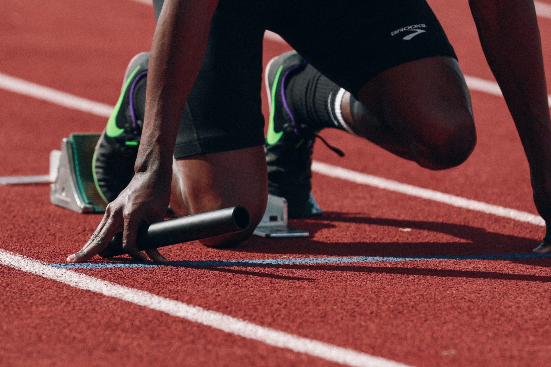 Vue des pieds d'un sprinter de relais dans les starting blocks
